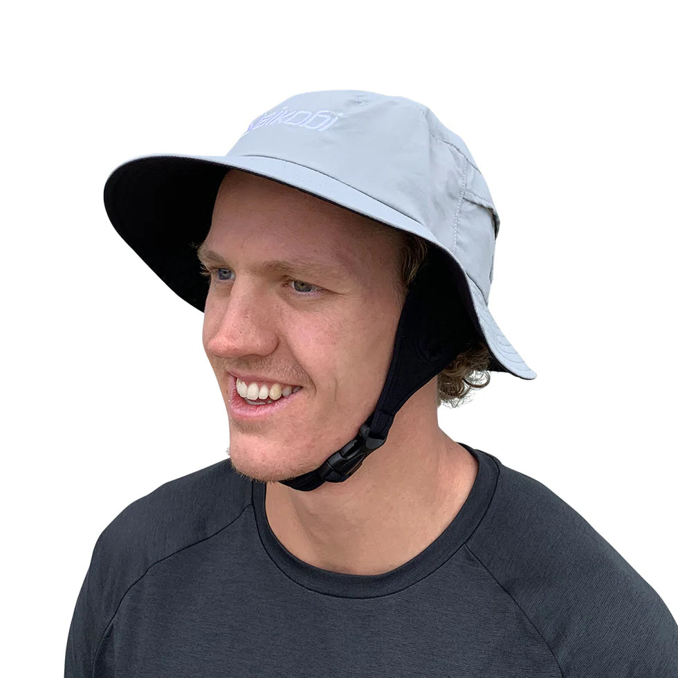 Vaikobi Downwind Surf Hat (VK-260) Person wearing a light blue bucket hat with black chin strap on a white background