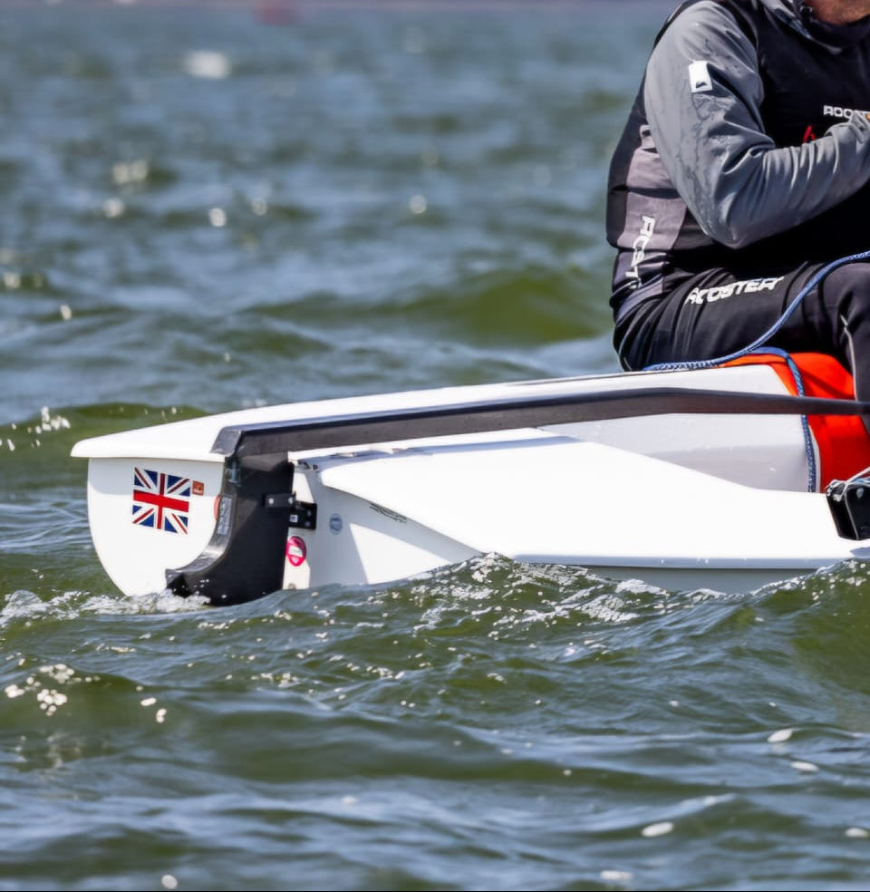Racing with a Finn Dinghy DEM Foils Carbon Fixed Rudder and Tiller - sleek black carbon fiber finish with optimal steering precision and feedback